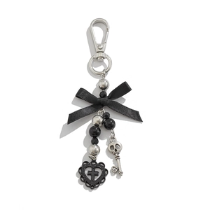 Detail of gothic keychain with black bow, silver beads, heart cross and skull key charms