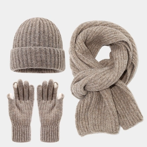 Detail of oat-colored knitted set showing touchscreen fingertips and rib texture