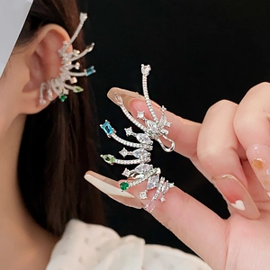 Detail of colorful crystal wing ear cuff in silver metal shown on model and hand