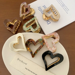 Elegant heart-shaped acetate hair claw clips in various colors and marble patterns