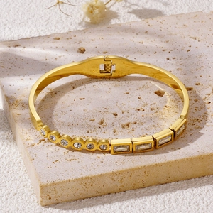 Elegant gold titanium steel bracelet featuring circular and rectangular zircon stones