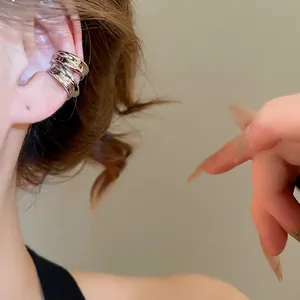Minimalist silver geometric double-loop ear bone clip on female model with polished finish