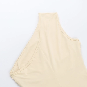 Detailed close-up of the elegant beige ruched one-shoulder neckline and smooth fabric
