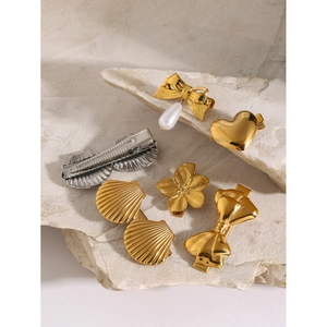 Set of six gold and silver hair clips featuring pearls and metallic bow shapes
