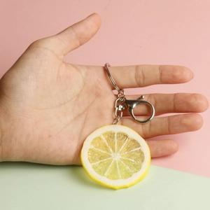 Realistic PVC lemon slice keychain featuring detailed fruit texture and metal lobster clasp