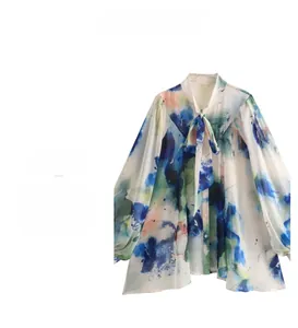 Λεπτομέρεια από πολύχρωμη tie-dye μπλούζα με φιόγκο και μανίκια φανάρια