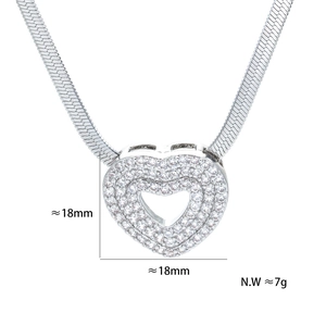 Macro shot of a silver heart pendant with pave cubic zirconia and flat snake chain detail