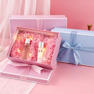 Pink and blue elegant gift boxes with satin bows and warm LED fairy light decoration