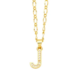 Detail of gold letter J pendant featuring micro-set cubic zirconia on a Figaro chain