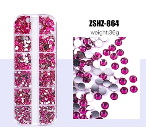 Detailed macro view of hot pink resin flatback nail art rhinestones in 12-slot storage box