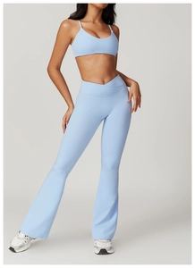 Detail of light blue sports bra and high-waisted flare leggings with V-waist design