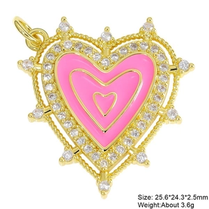 Macro detail of a pink enamel heart pendant with cubic zirconia inlay and gold plating