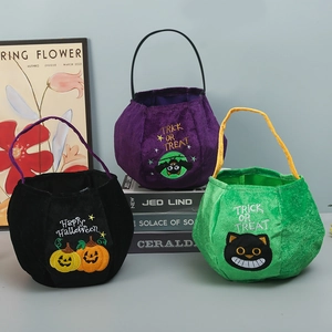 Three velvet Halloween candy bags with pumpkin, bat, and black cat embroidery detail