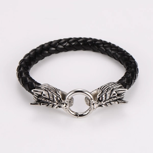 Detail of Viking dragon heads on braided leather bracelet with retro silver finish