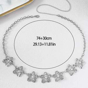Macro detail of a silver flower waist chain with white pearls and 74+30cm size measurements