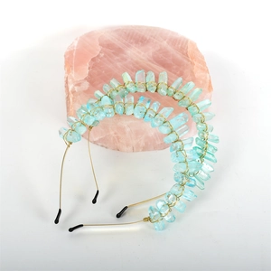 Detail of handcrafted gold wire headband featuring raw light blue crystal stones