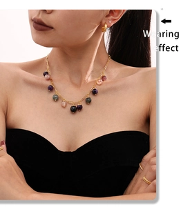 Detailed view of bohemian gold chain necklace with colorful natural stone beads on a model