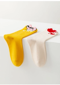 Close-up of cute cartoon cat and heart patterns on yellow and beige cotton mid-calf socks
