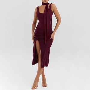 Detail of burgundy mesh dress featuring side slit with elegant 3D flower and ruching