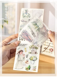 Close-up of vintage girl and floral illustrations in a spiral-bound sticker book