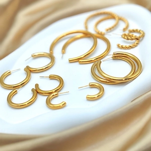 Selection of diverse gold plated stainless steel hoop earrings in various textures and sizes