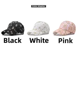 Detailed close-up of floral embroidery on black, white, and pink baseball caps