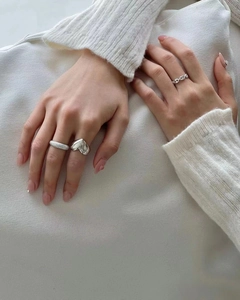 Three-piece 925 sterling silver ring set featuring heart, twist, and chain link designs