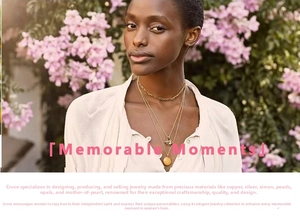 Detailed view of layered gold necklaces with circular pendant on a model in a garden