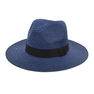 Detailed close-up of dark blue woven straw Fedora hat featuring a classic black ribbon band