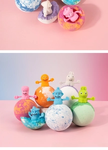 Macro shot of colorful 100g bath bombs with cute cartoon finger puppet toy toppers