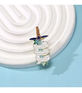 Macro shot of Fighting Invisible Battles enamel pin with blue flowers on white base