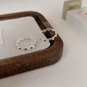 S925 sterling silver hollow heart ring with black and white gemstones in a minimalist style