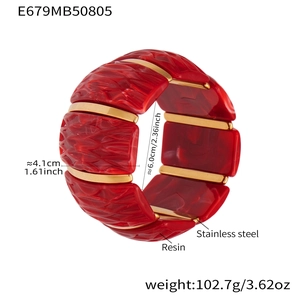 Detail showing 4.1cm width and 6cm diameter of the red resin and gold stainless steel cuff
