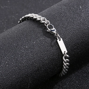 Detail of silver stainless steel Cuban link bracelet with engravable blank rectangular bar