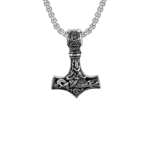Detail of silver Mjolnir pendant with intricate Celtic knots and animal engraving patterns