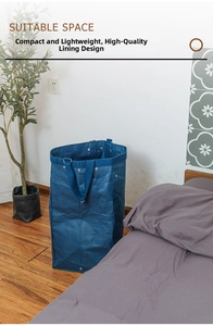 Detail of blue washable kraft paper laundry basket with durable handles on wood floor