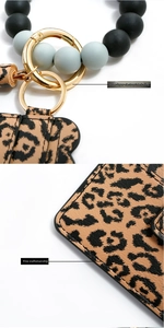 Detail of leopard print PU card holder with gold alloy clasp and matte beaded wristlet