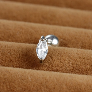 Macro shot of marquise-cut zircon stud with screw ball back on brown velvet