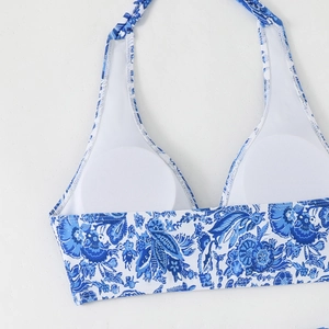 Detail of blue and white bikini top featuring removable breast pads and halter neck ties