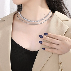 Silver double-layer necklace with crystal tennis chain and smooth snake chain on model
