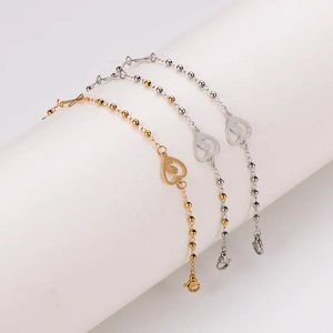 Polished stainless steel beaded bracelets with hollow heart and cross charms in gold and silver