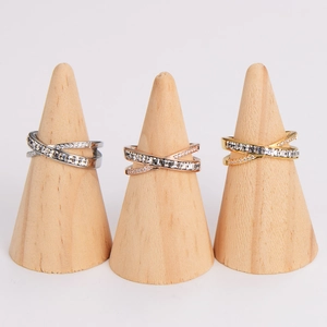 Crisscross stainless steel rings with diamonds in silver, gold, and rose gold finishes
