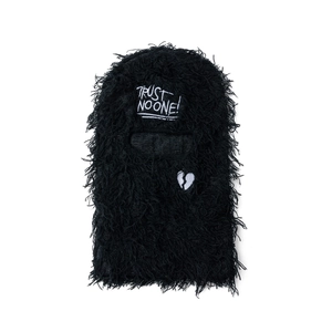 Detailed close-up of plush black balaclava with Trust No One embroidery and heart design