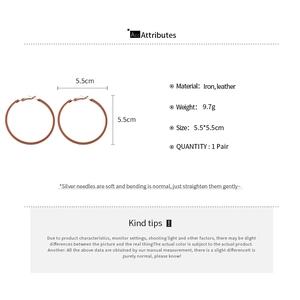 Detail showing 5.5cm round leather-wrapped iron hoop earrings with silver pins for women