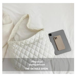 Detailed comparison of white quilted tote bag size next to a tablet and smartphone