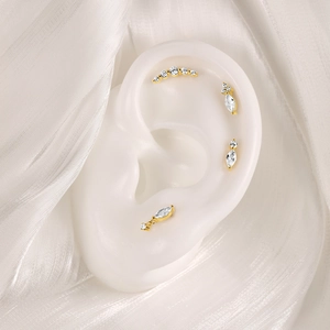 Detailed view of S925 silver gold-plated cartilage studs with zircon on ear model