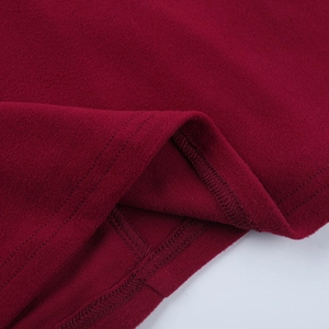 Macro shot of double-stitched hem on burgundy knit dress showcasing premium sewing quality
