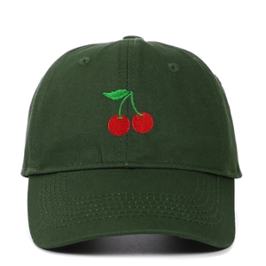 Close-up of cherry embroidery on a dark green cotton baseball cap with fine stitching