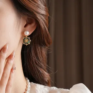 French vintage gold earrings with white pearl and celestial starburst coin pendant