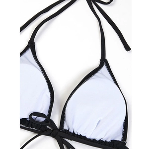 Detail of black bikini top featuring breathable mesh lining and removable round chest pads